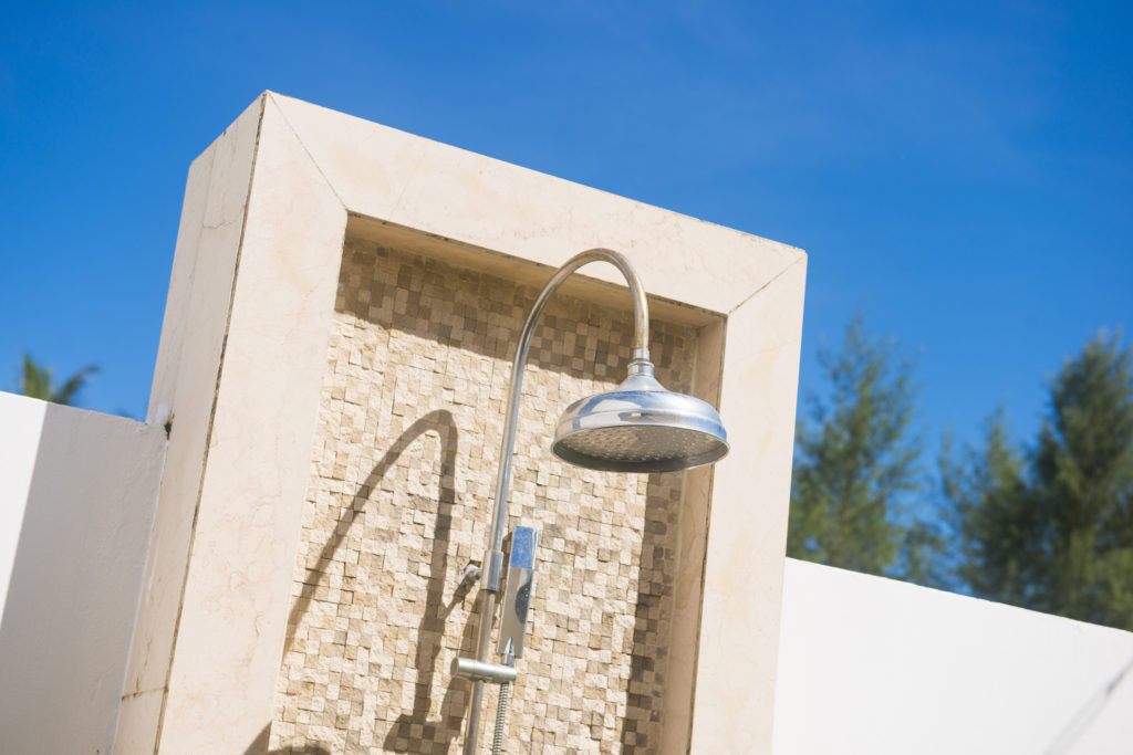 outdoor shower head with brick wall, clean